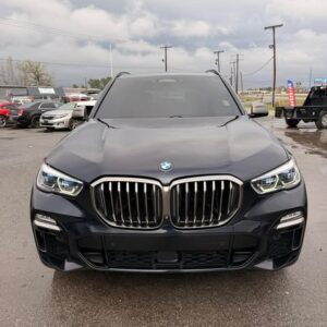 Front view of a black BMW SUV parked outdoors on a cloudy day.
